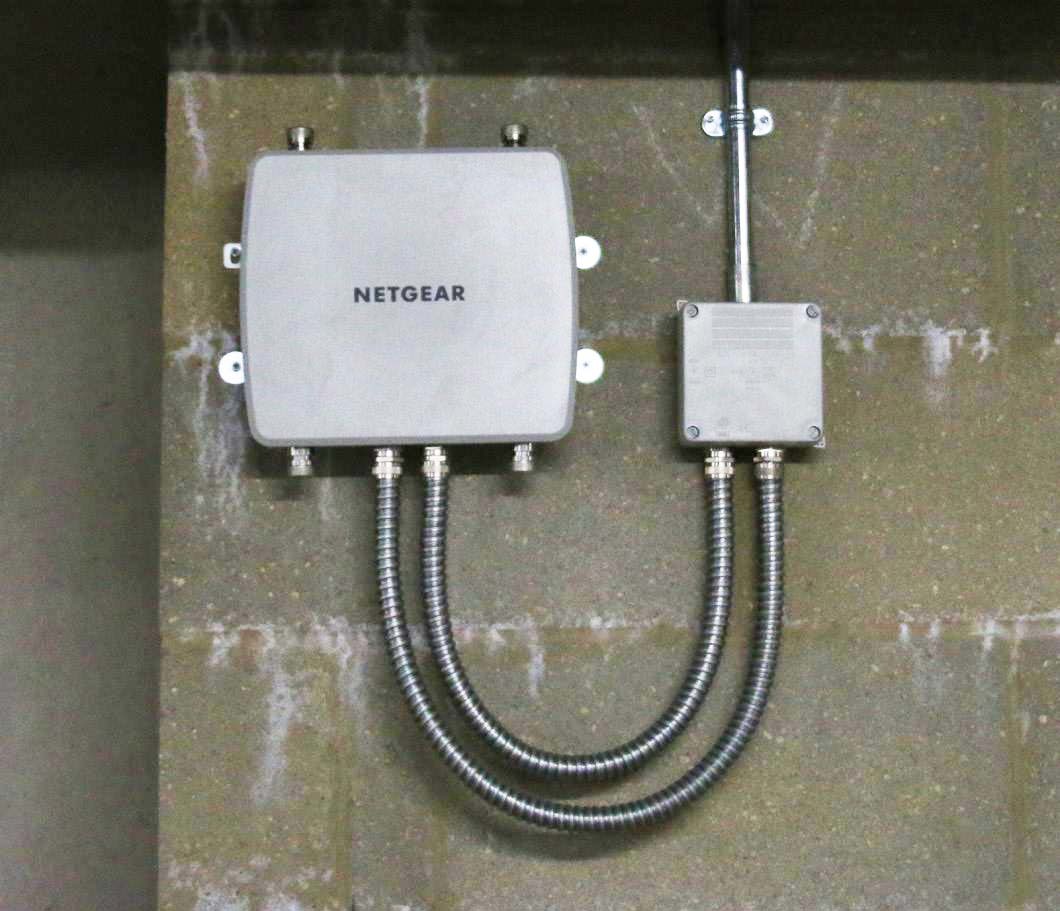 A close up of Devon Road's Wi-fi system installed on a  large brick wall