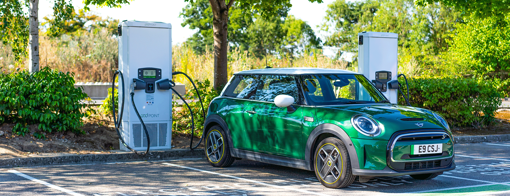 Racing green Mini plugged in to Pod Point Velocity rapid charger