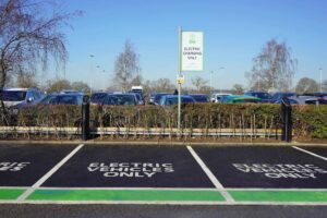 Two Pod Point twin chargers in a car park, with clearly signed EV charging bays
