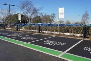 Side view of 4 Pod Point twin chargers and their clearly signed EV charging bays