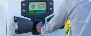 man tapping his debit card onto the contactless reader of a Pod Point Velocity rapid charger