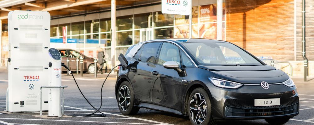 An electric car plugged into a public Twin Pod Point charger