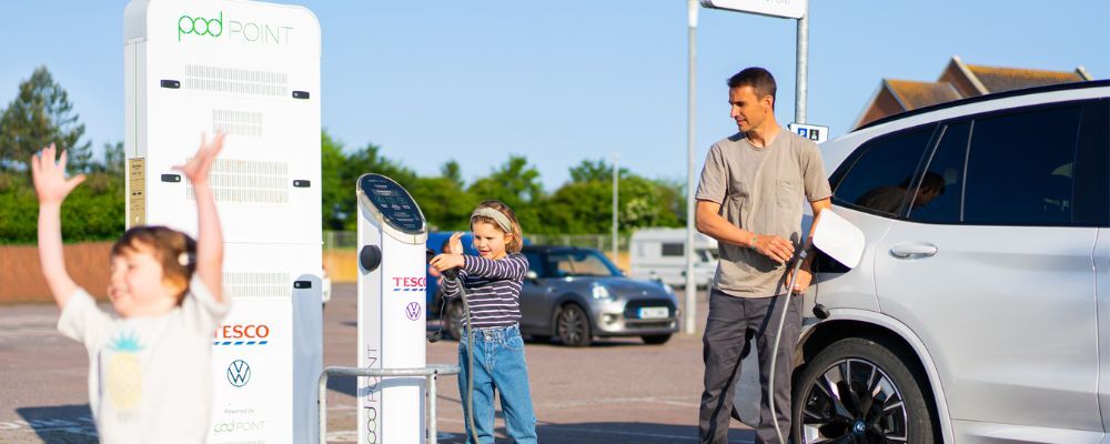 Family using Pod Point Media charger at a Tesco car park