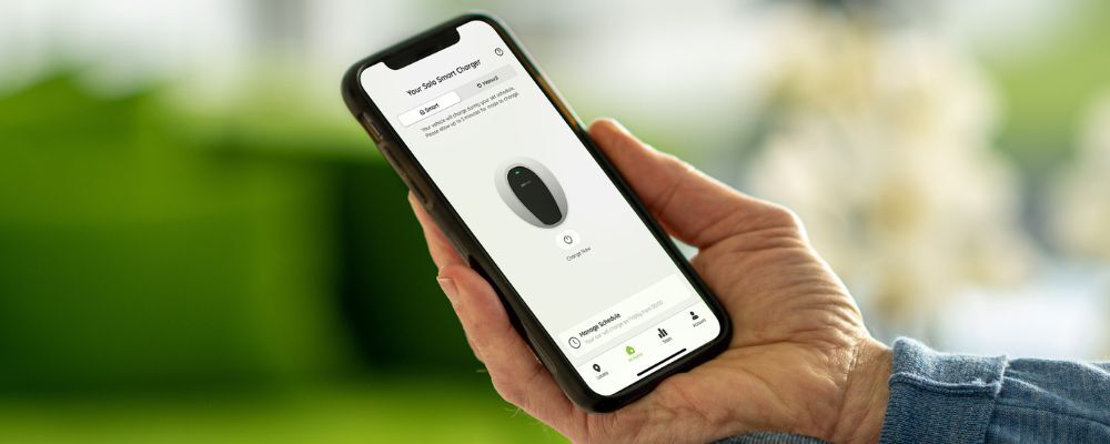 Person holding mobile phone showing Pod Point App's new Charge Now button
