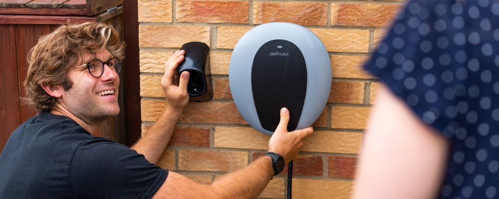 Pod Point electrician installing a charger to the exterior of a house