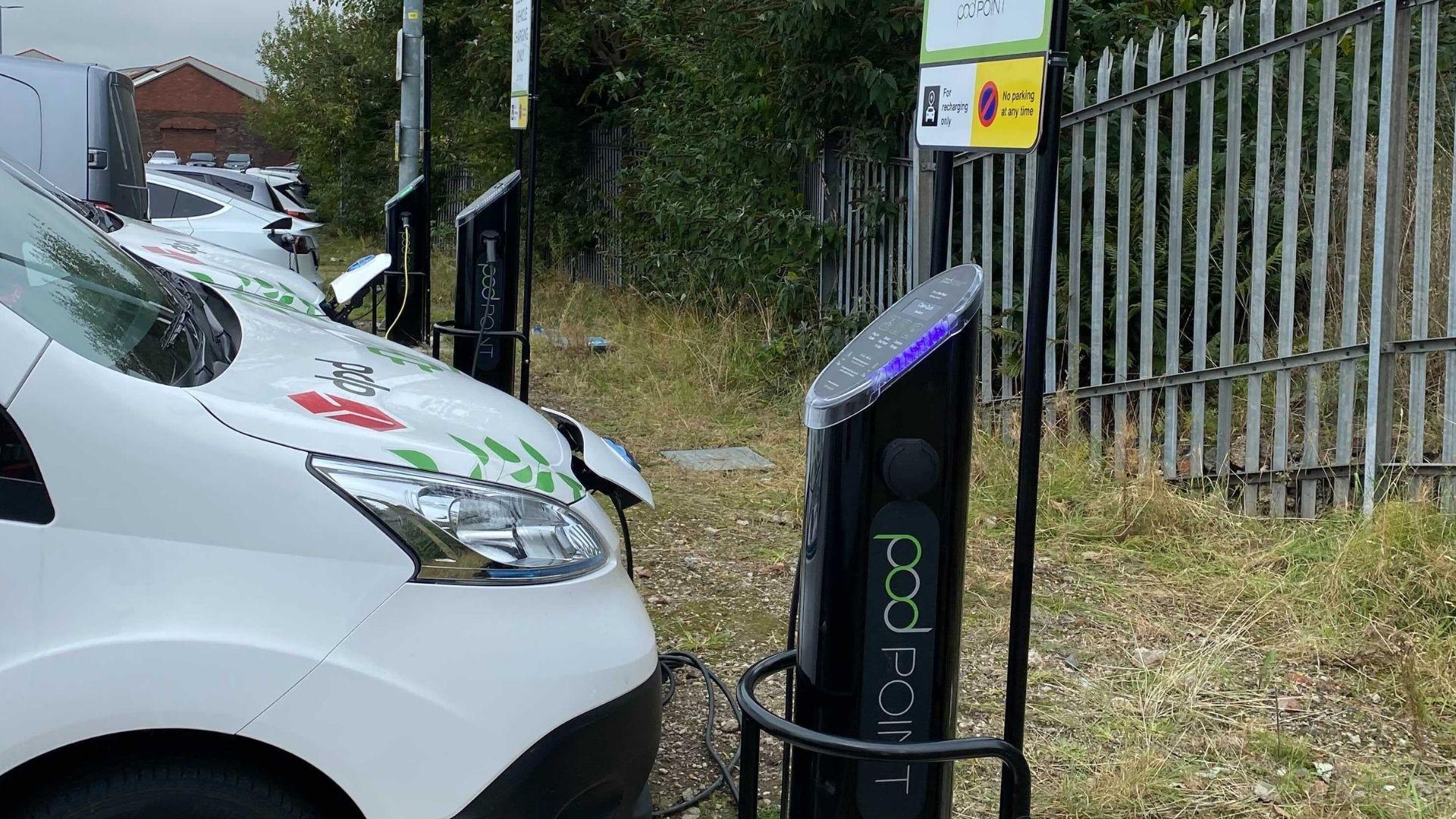 A close up shot of the front of a DPD electric van plugged into a Pod Point twin charger in a car park
